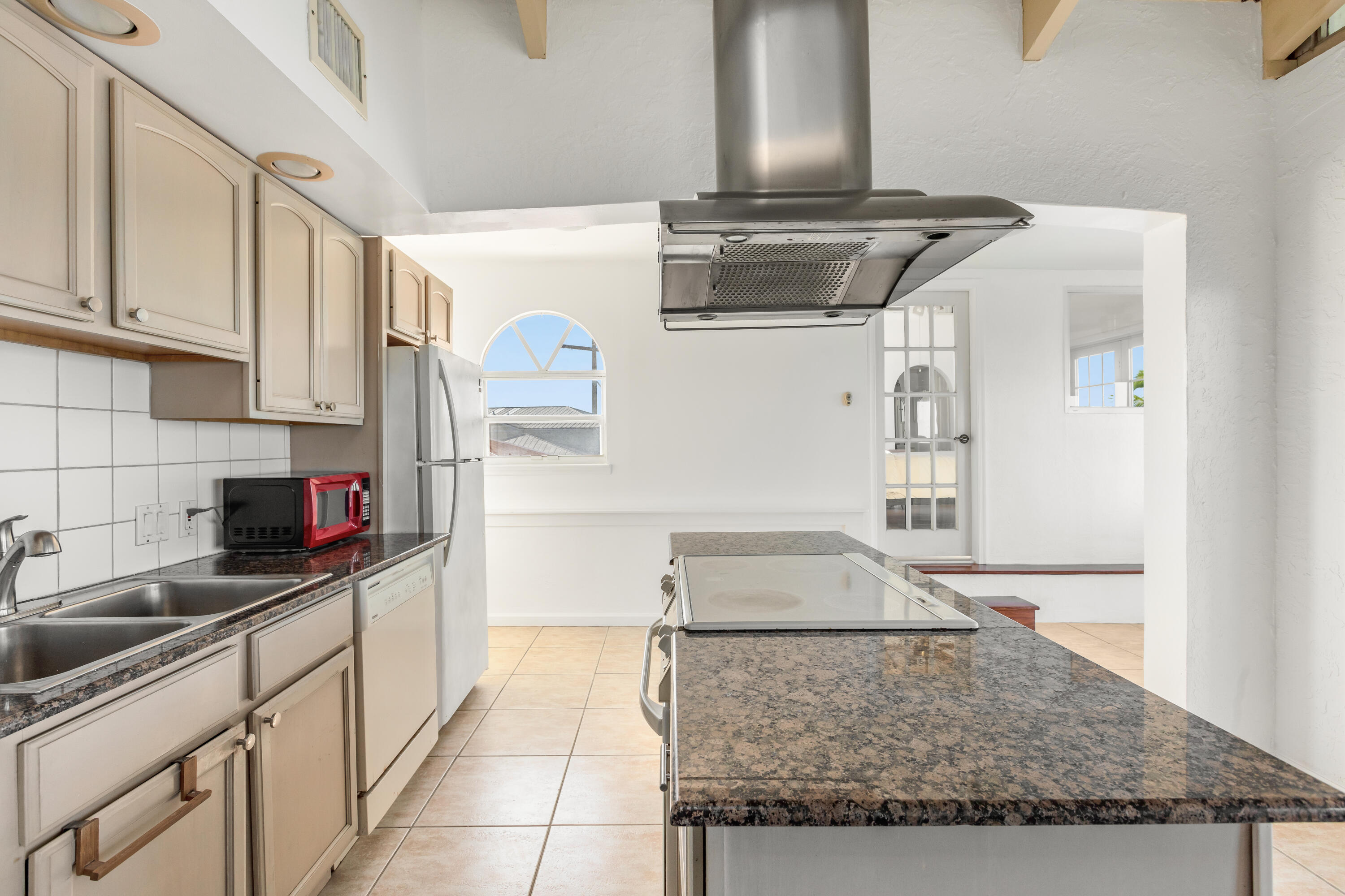 32 Hilton Haven Road, Unit 6 Key West, FL 33040 - Photo 14 of 26 a kitchen with stainless steel appliances granite countertop a sink stove and white cabinets