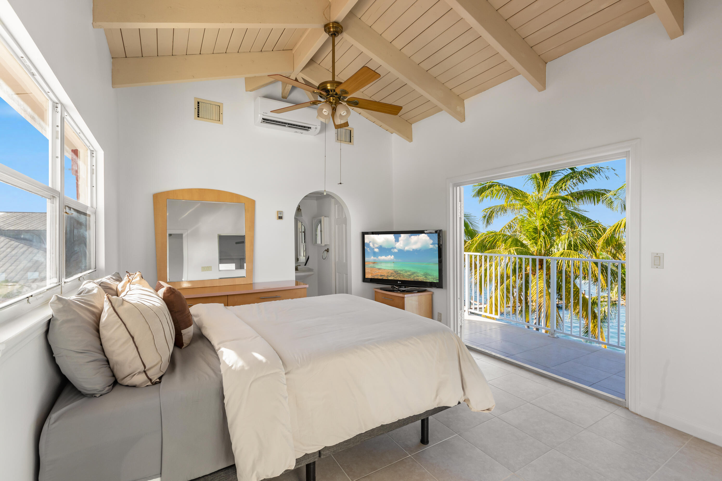 32 Hilton Haven Road, Unit 6 Key West, FL 33040 - Photo 15 of 26 a bedroom with a bed and a painting on the wall