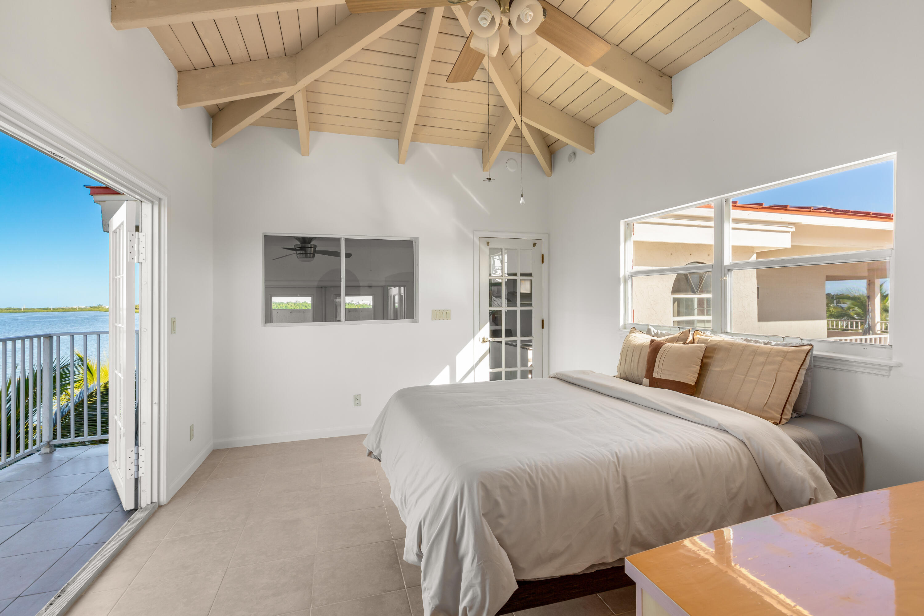 32 Hilton Haven Road, Unit 6 Key West, FL 33040 - Photo 16 of 26 a bedroom with beds and a large window