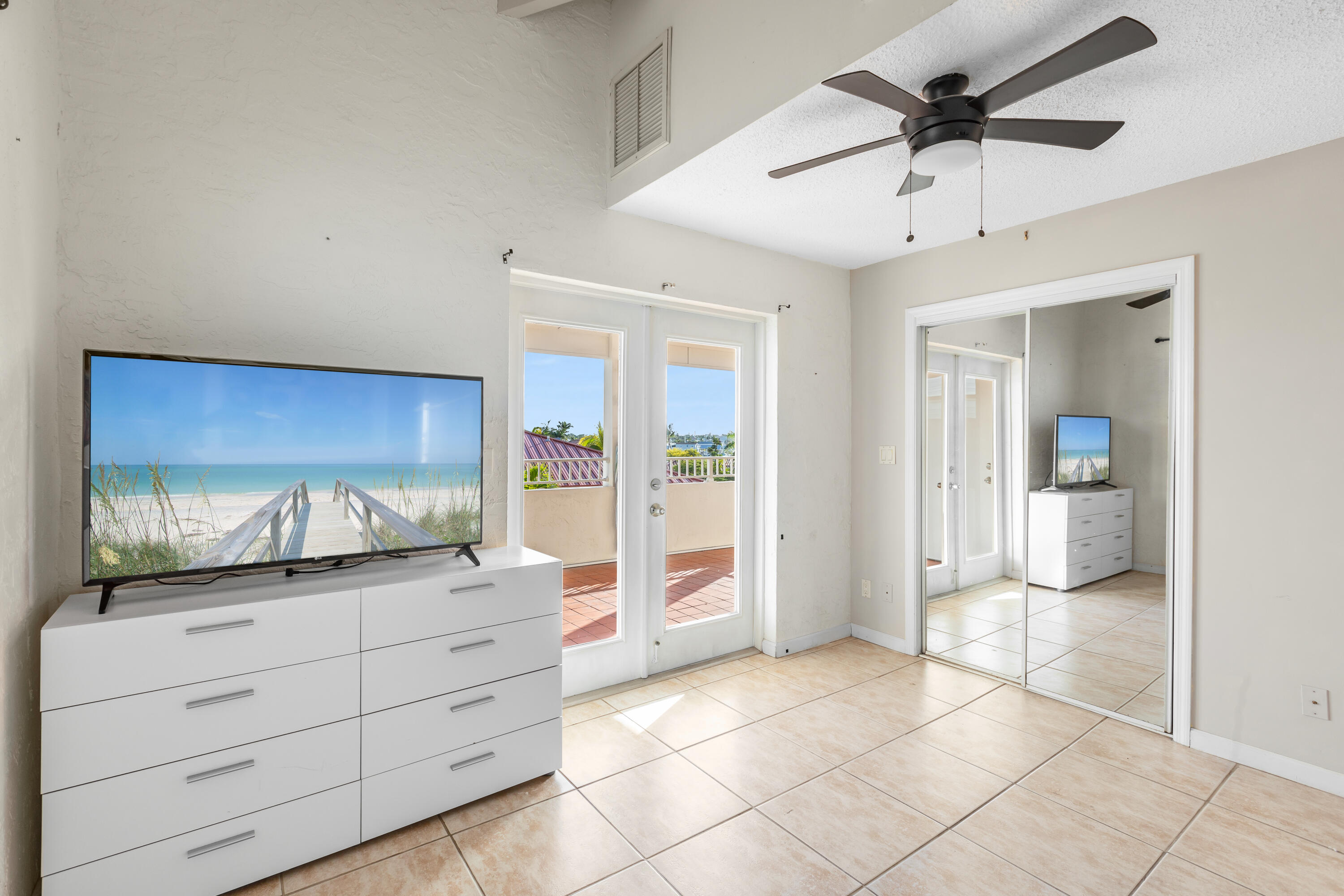32 Hilton Haven Road, Unit 6 Key West, FL 33040 - Photo 19 of 26 a view of room with cabinet and flat screen tv