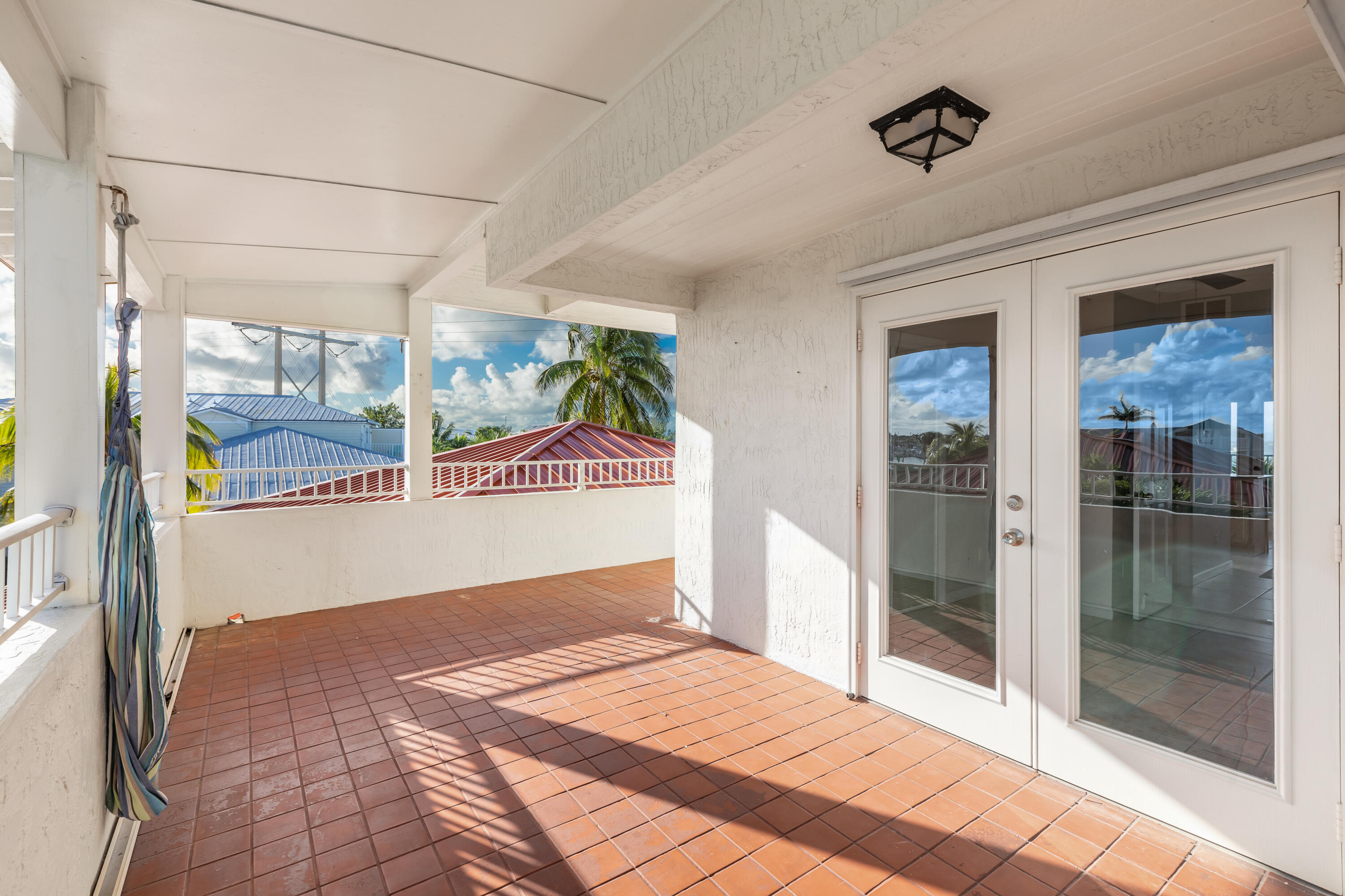 32 Hilton Haven Road, Unit 6 Key West, FL 33040 - Photo 20 of 26 a bedroom with a bed and a glass door shower
