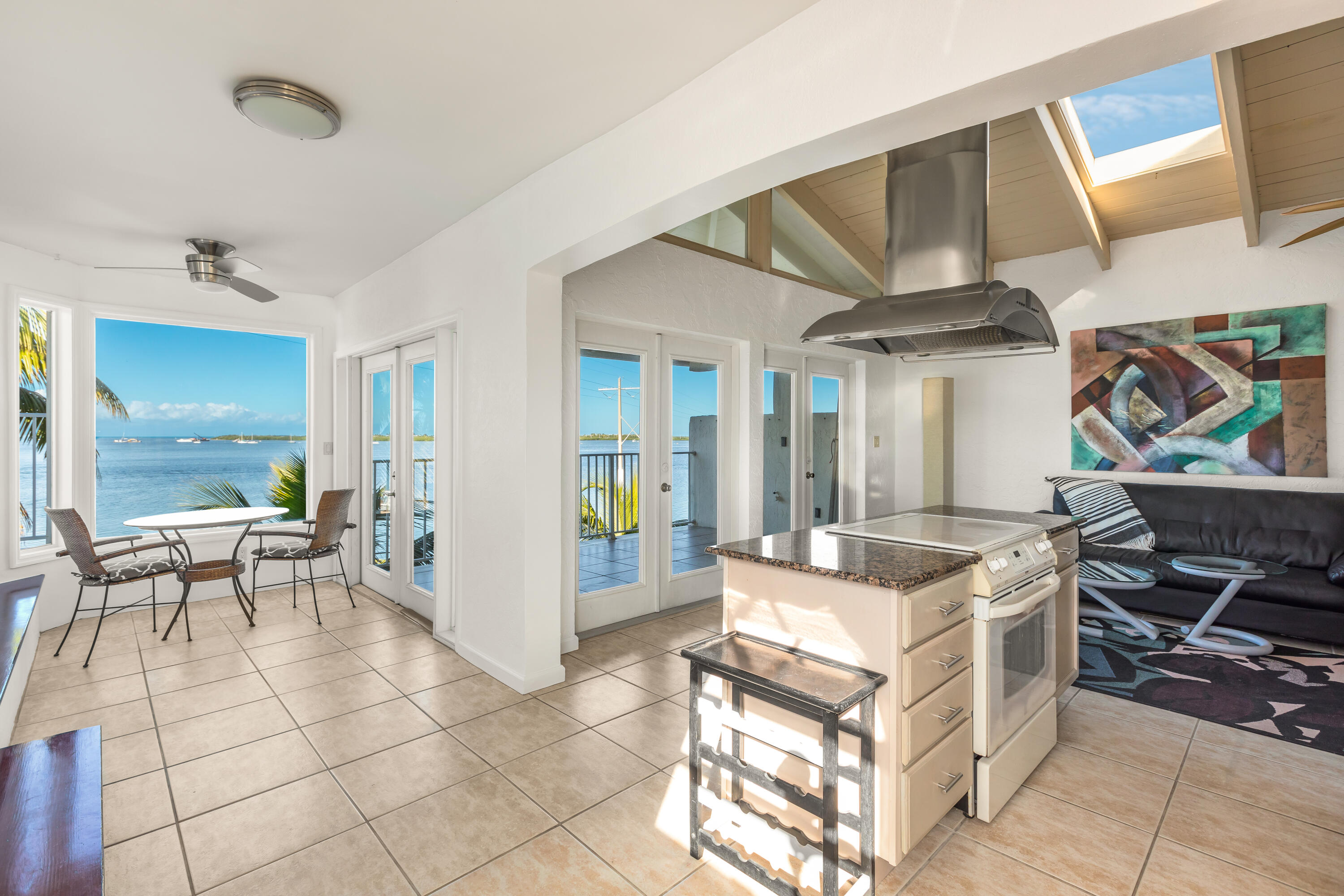 32 Hilton Haven Road, Unit 6 Key West, FL 33040 - Photo 6 of 26 a living room with patio furniture and a dining table