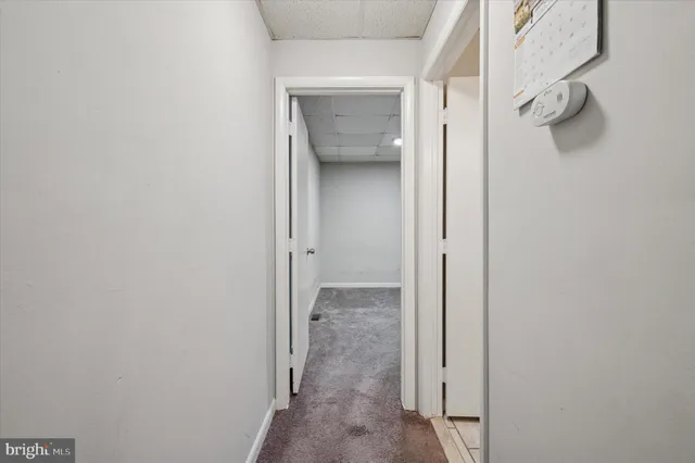 a bathroom with a granite countertop toilet a sink and a mirror
