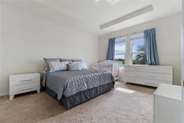 a bed sitting in a bedroom next to a bathroom