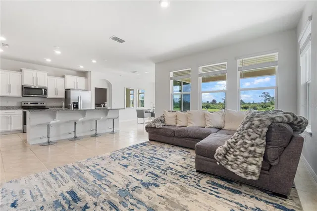 a kitchen with stainless steel appliances kitchen island granite countertop a stove and cabinets
