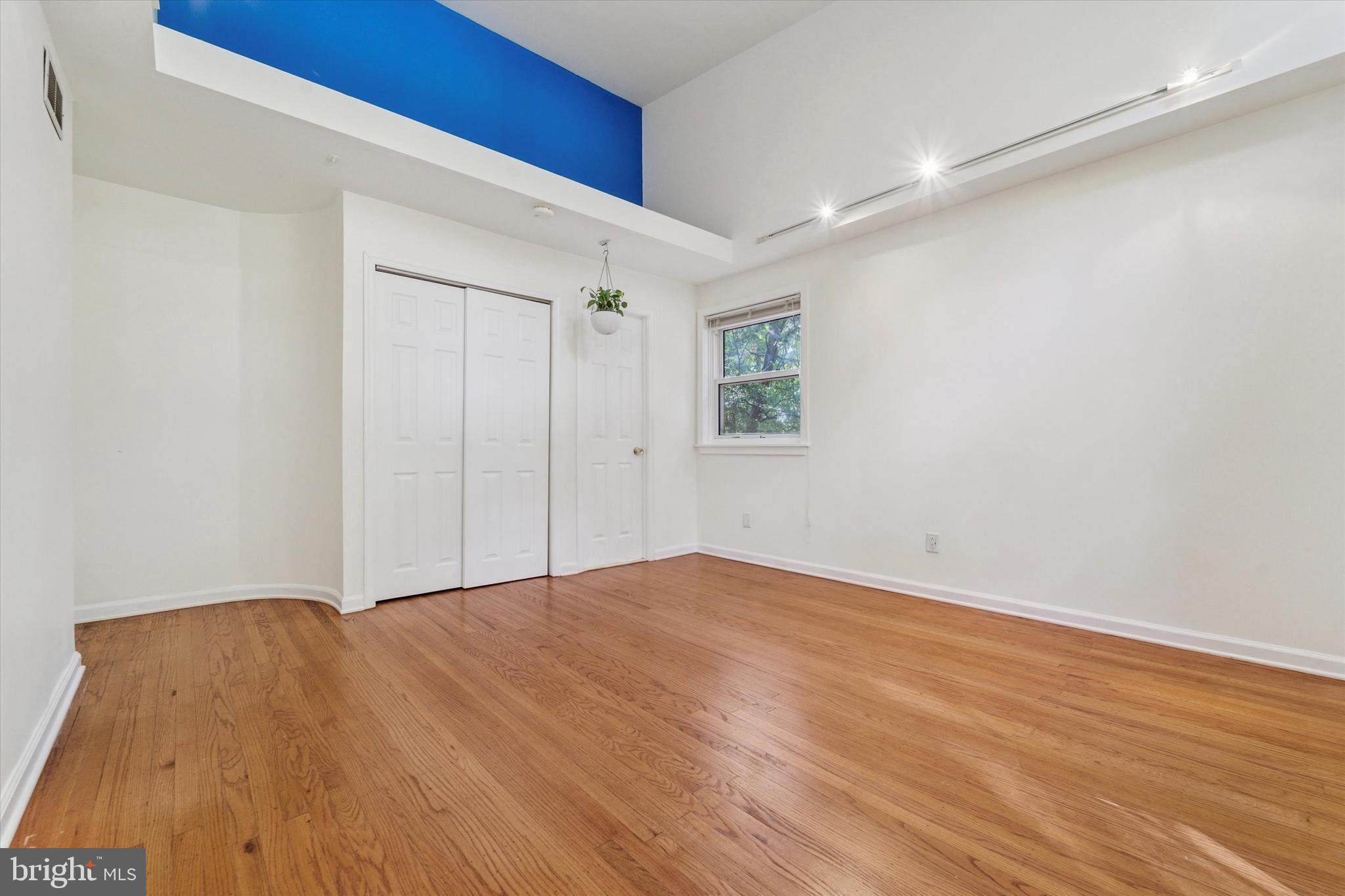 679 Crestwood Road Wayne, PA 19087 - Photo 12 of 19 a view of an empty room with wooden floor and a window