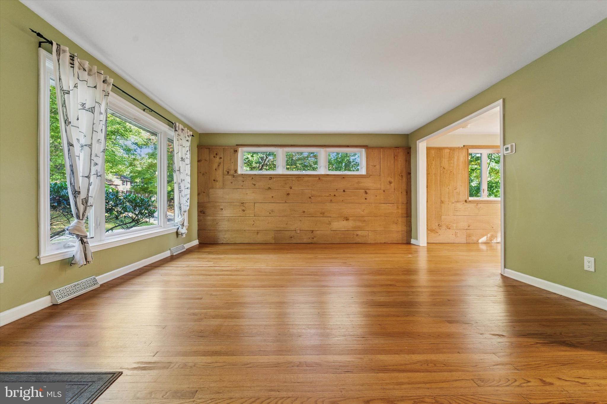679 Crestwood Road Wayne, PA 19087 - Photo 3 of 19 a view of an empty room with wooden floor and a window