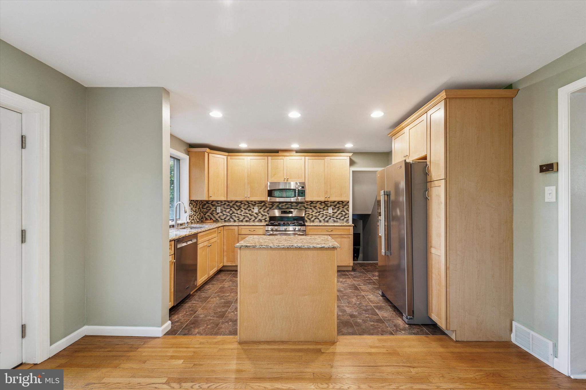 679 Crestwood Road Wayne, PA 19087 - Photo 8 of 19 a kitchen with stainless steel appliances granite countertop a refrigerator a sink and a stove