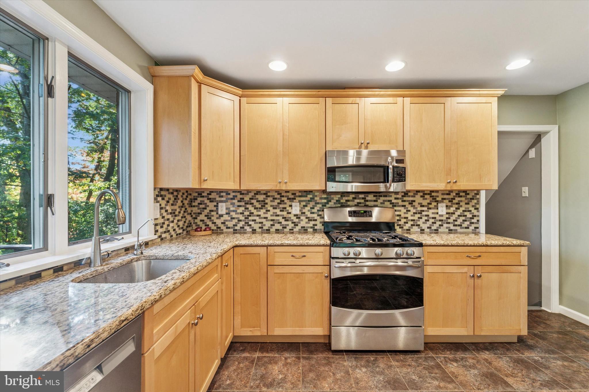 679 Crestwood Road Wayne, PA 19087 - Photo 10 of 19 a kitchen with a stove a sink and a microwave