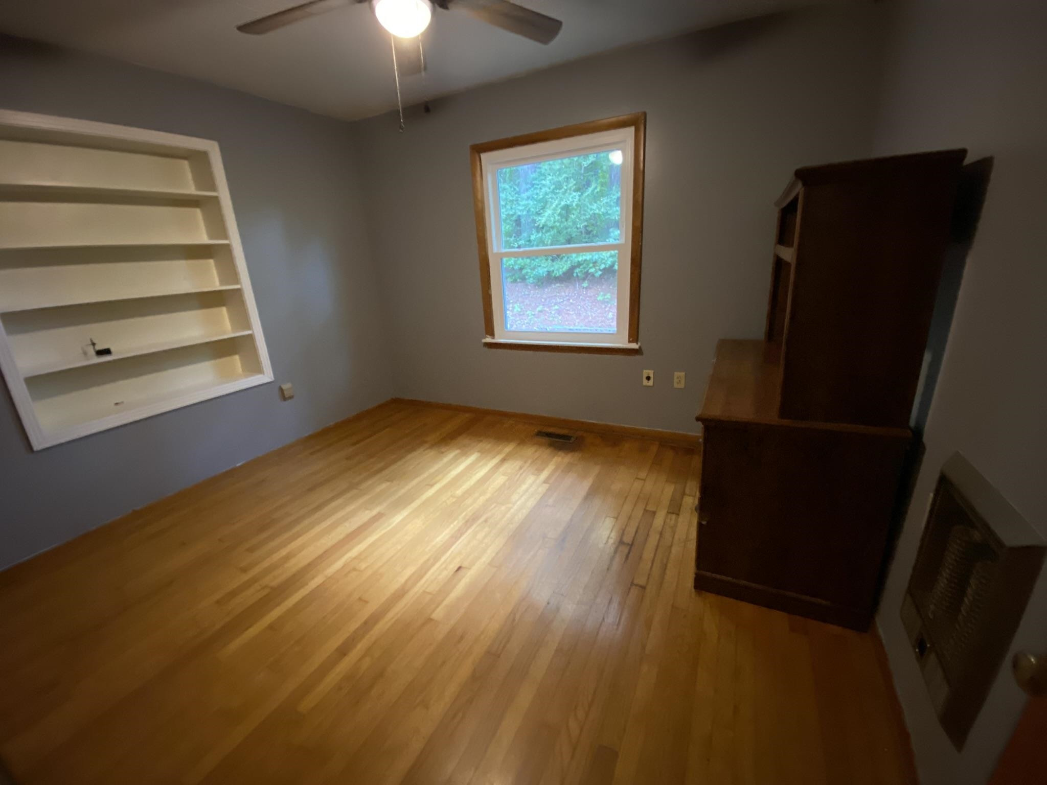 639 Beacon Road Parsons, TN 38363 - Photo 12 of 26 a view of an empty room with wooden floor and a window