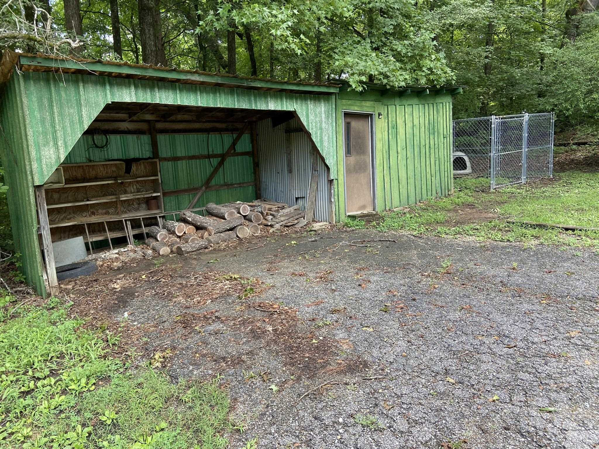 639 Beacon Road Parsons, TN 38363 - Photo 18 of 26 a backyard of a house with barbeque oven table and chairs