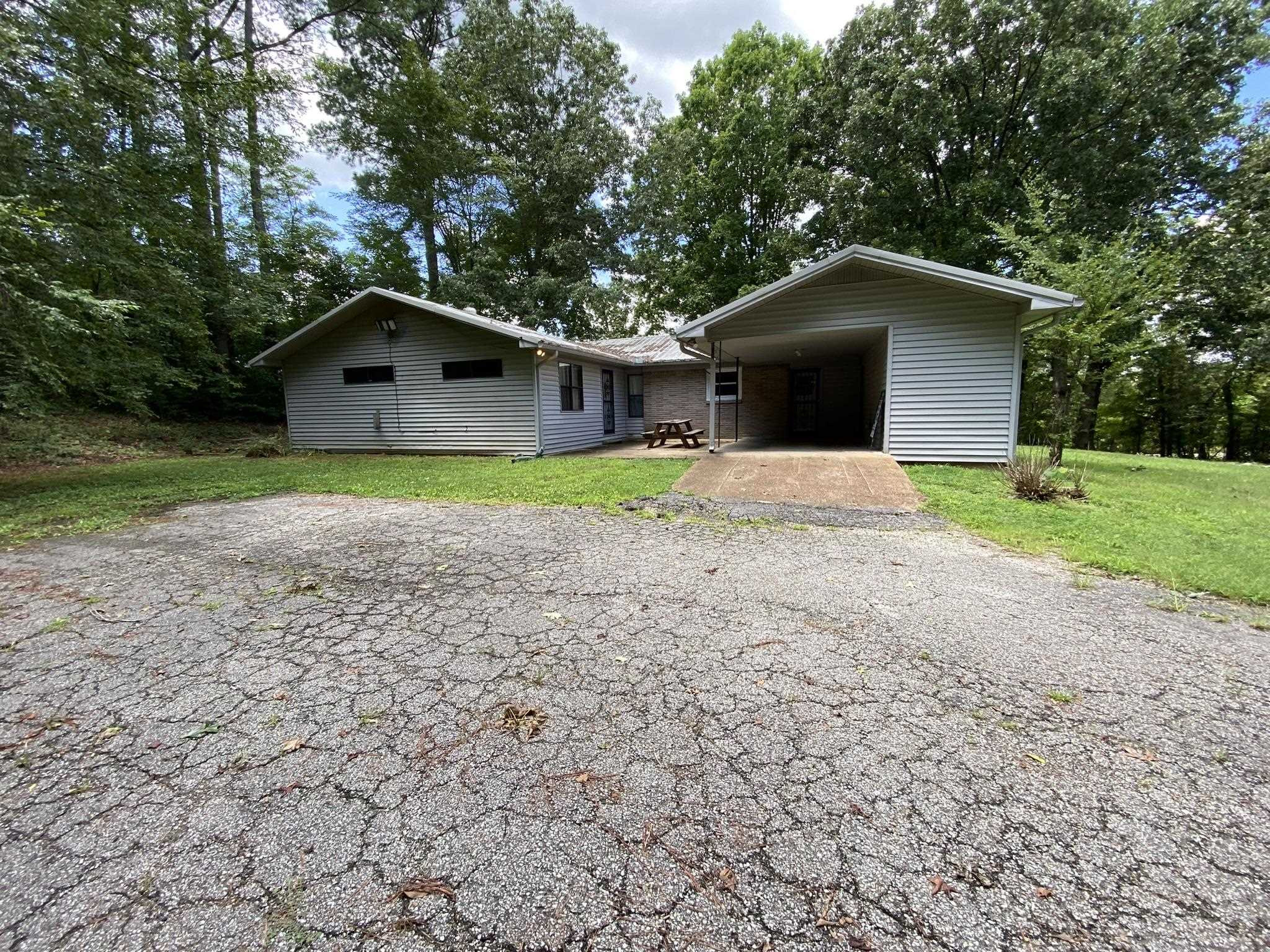 639 Beacon Road Parsons, TN 38363 - Photo 20 of 26 a front view of a house with a yard and trees