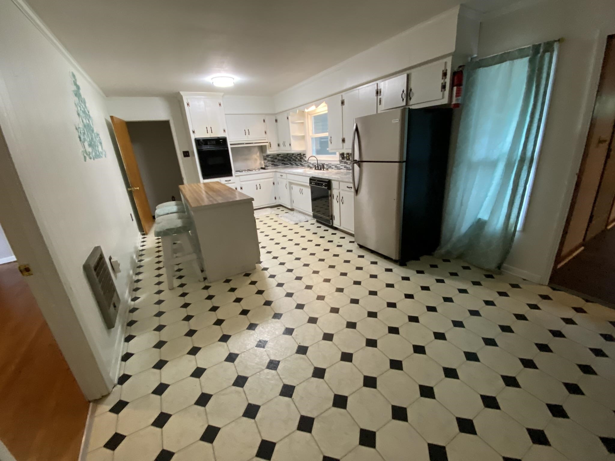 639 Beacon Road Parsons, TN 38363 - Photo 3 of 26 a kitchen with a refrigerator and a sink
