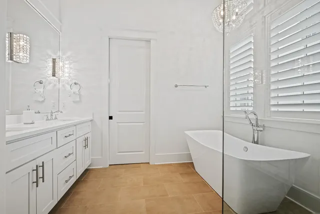 a bathroom with a double vanity sink toilet and shower