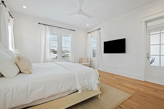 a bedroom with a bed and wooden floor