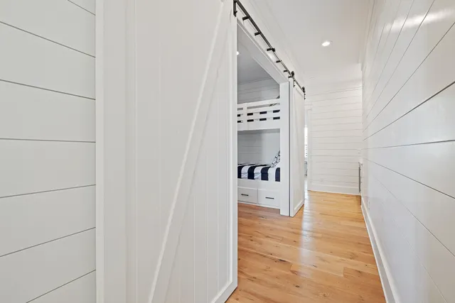 an aerial view of a residential houses with outdoor space and trees