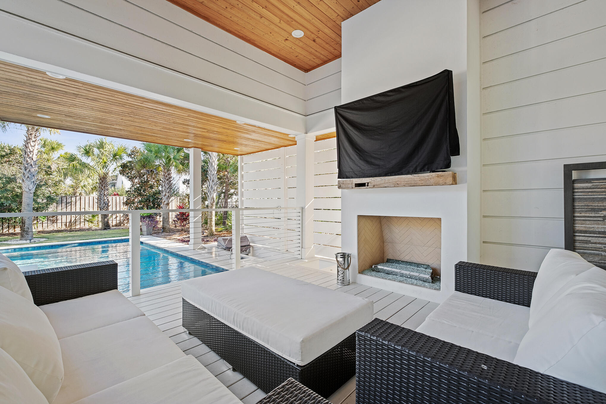 27 Sand Dunes Road Santa Rosa Beach, FL 32459 - Photo 61 of 74 a living room with furniture a flat screen tv and a fireplace