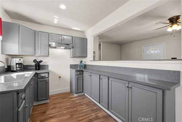 a kitchen with a sink stove and cabinets