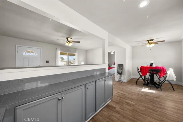 a kitchen with a sink cabinets and a wooden floor