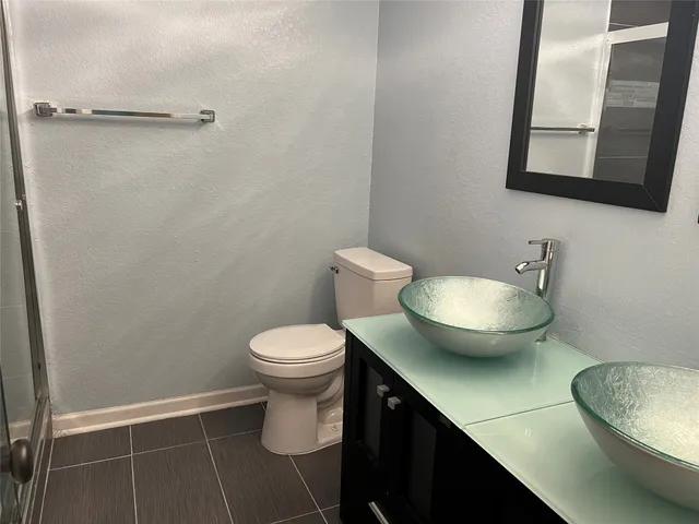 a bathroom with a toilet and a mirror