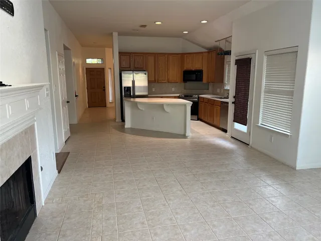 a large kitchen with cabinets and stainless steel appliances
