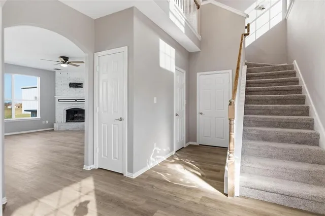 a view of an entryway with wooden floor and staircase