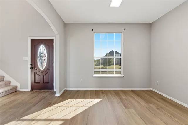 a view of wooden floor and windows in a room