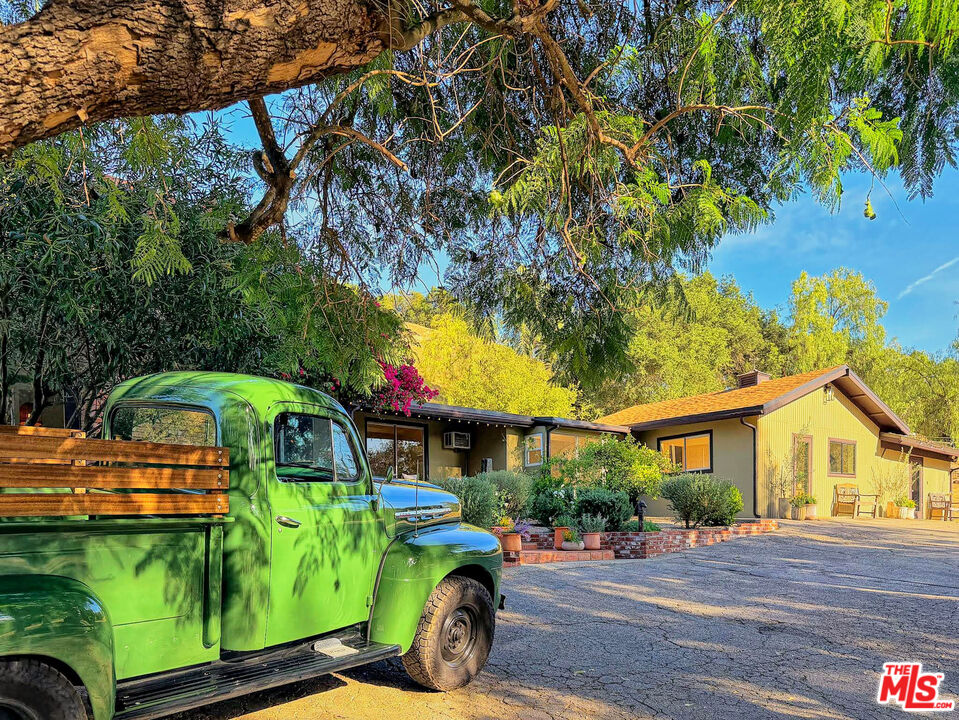 a front view of house with outdoor space and swimming pool