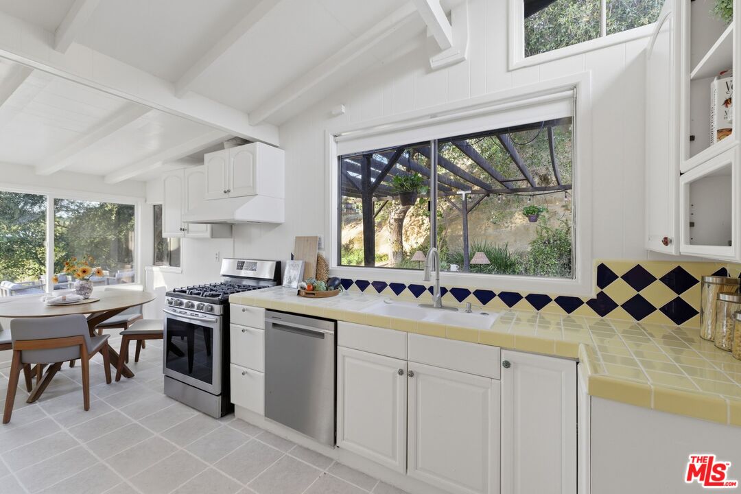 3100 Santa Maria Road Topanga, CA 90290 - Photo 13 of 66 a kitchen with a sink stove and cabinets
