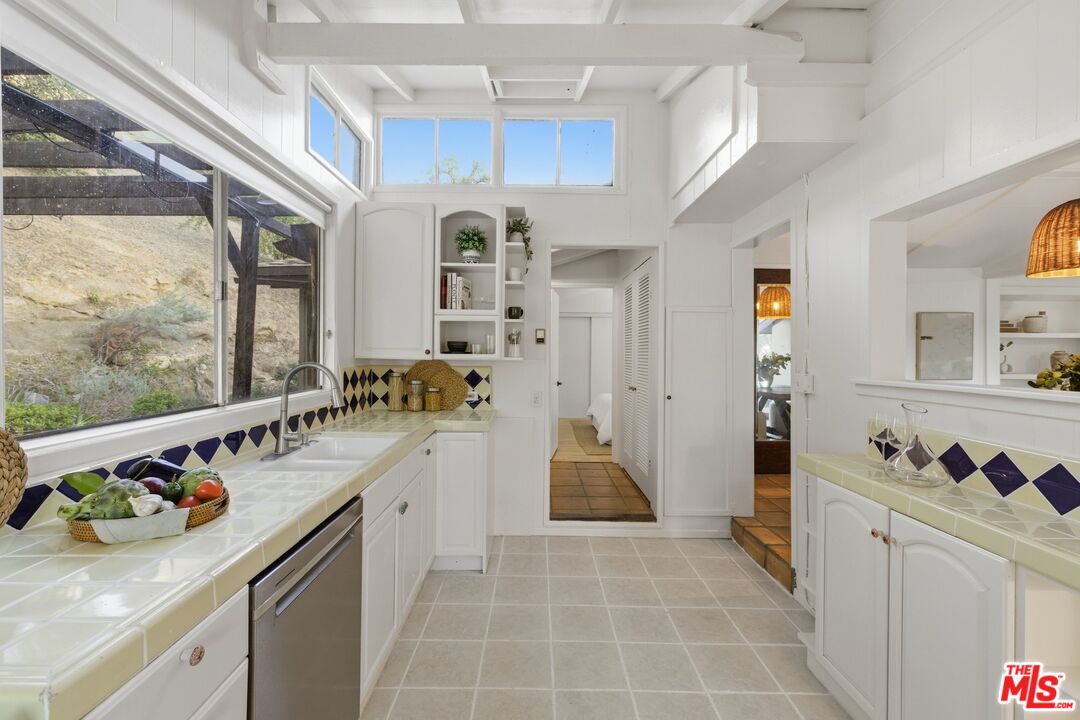 3100 Santa Maria Road Topanga, CA 90290 - Photo 14 of 66 a kitchen with stainless steel appliances granite countertop a sink and cabinets