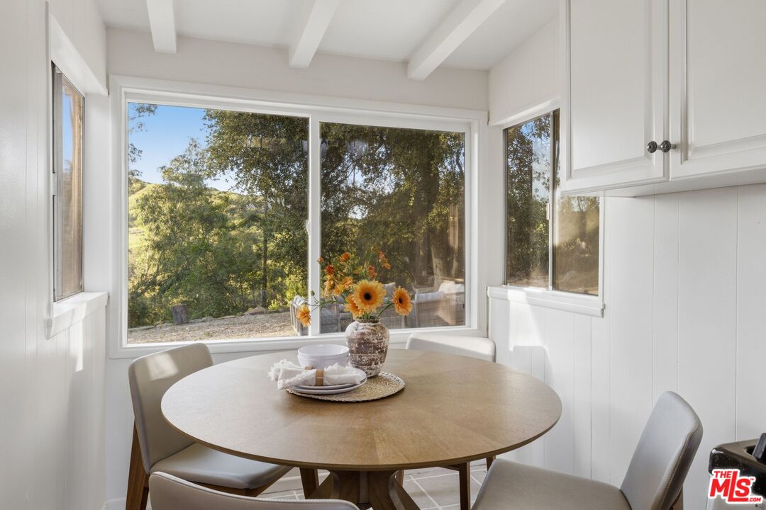 3100 Santa Maria Road Topanga, CA 90290 - Photo 15 of 66 a view of a dining room with furniture window and outside view