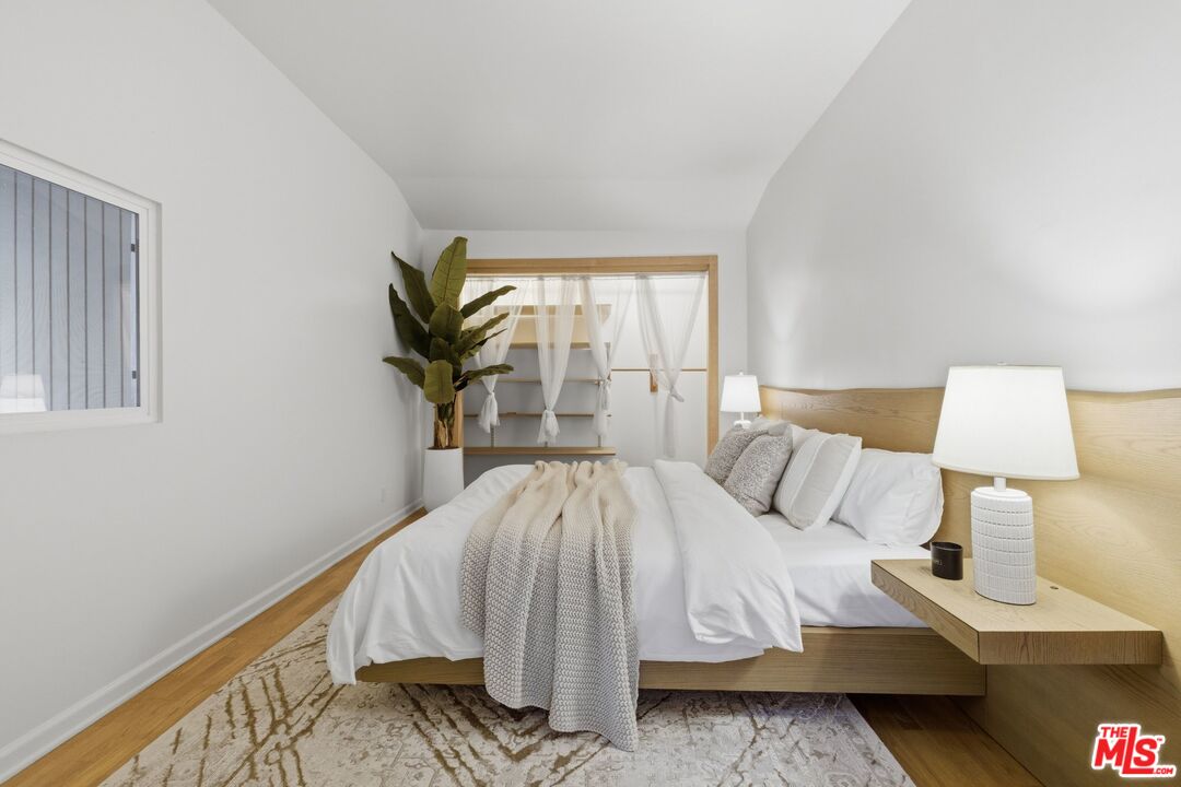 3100 Santa Maria Road Topanga, CA 90290 - Photo 19 of 66 a bed sitting in a bedroom next to a window with lamp