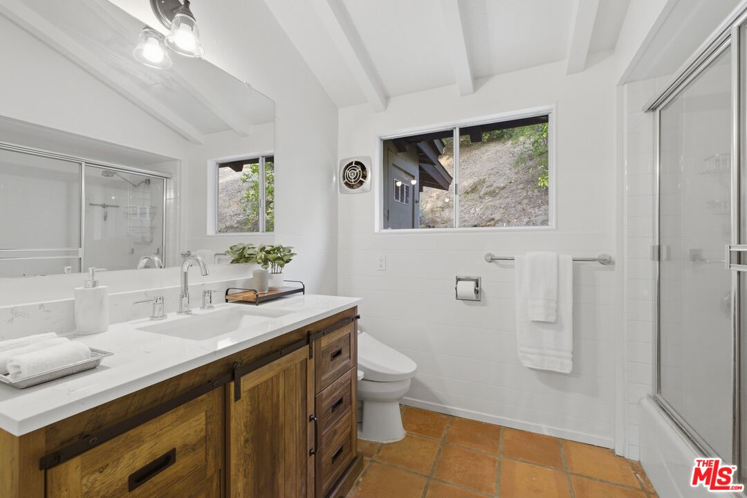 3100 Santa Maria Road Topanga, CA 90290 - Photo 23 of 66 a bathroom with a granite countertop sink a toilet and a mirror