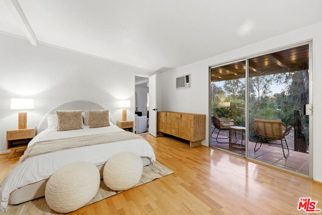 3100 Santa Maria Road Topanga, CA 90290 - Photo 25 of 66 a spacious bedroom with a bed and glass door