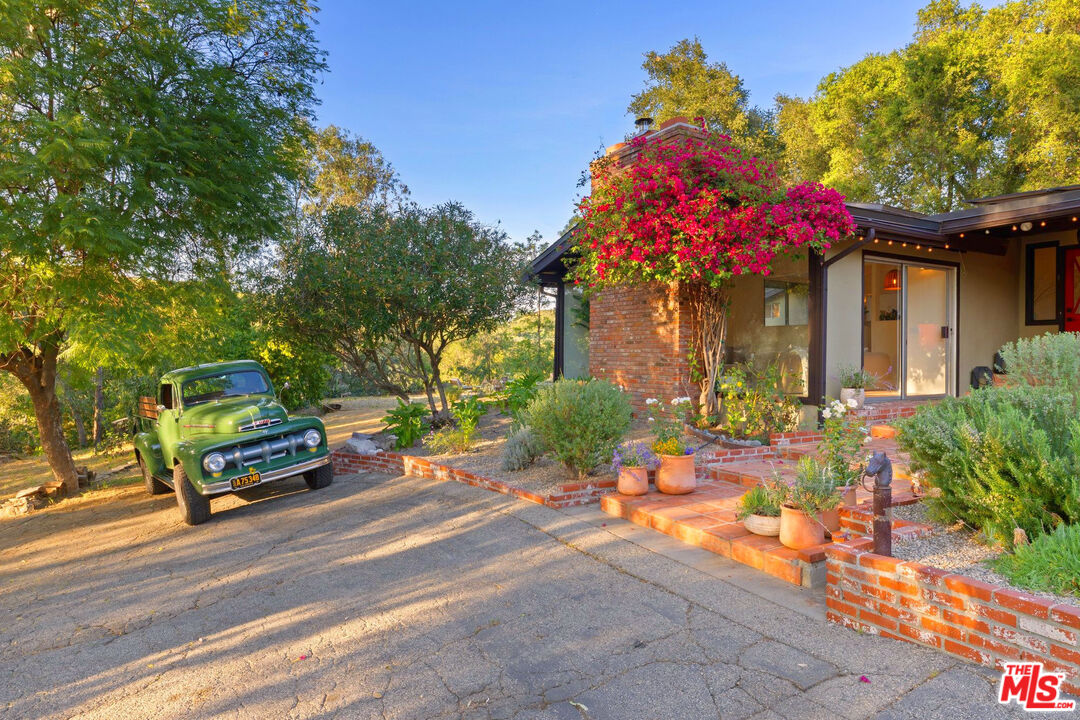 3100 Santa Maria Road Topanga, CA 90290 - Photo 31 of 66 a front view of a house with a garden