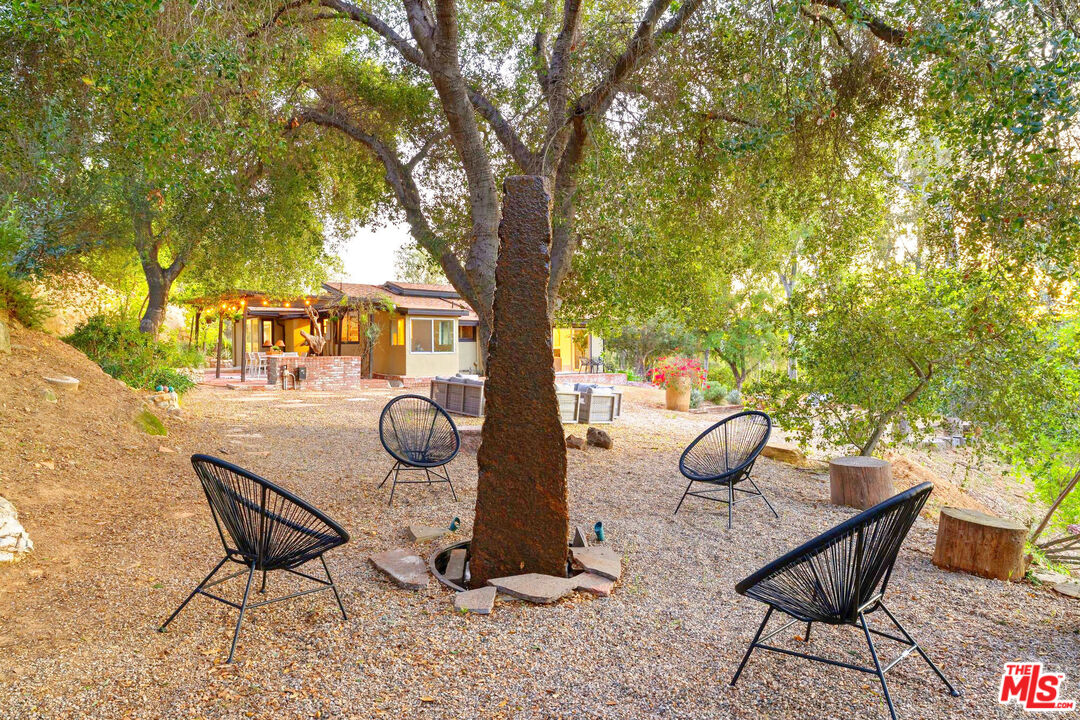 3100 Santa Maria Road Topanga, CA 90290 - Photo 34 of 66 a backyard of a house with table and chairs