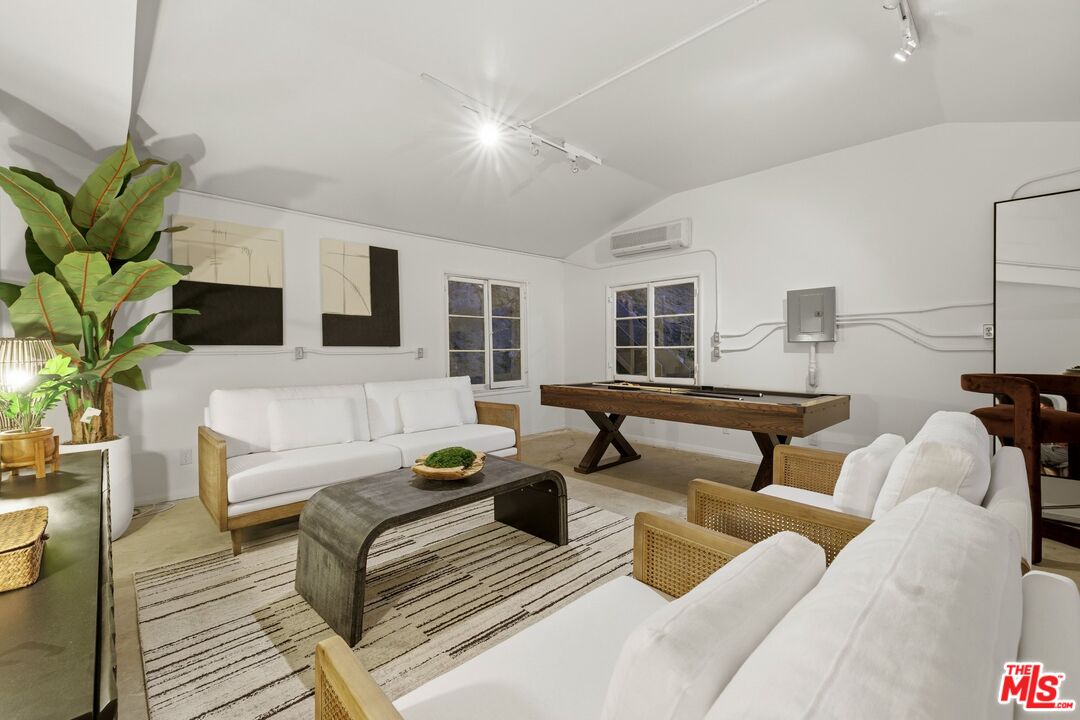 3100 Santa Maria Road Topanga, CA 90290 - Photo 35 of 66 a living room with furniture a fireplace and a potted plant