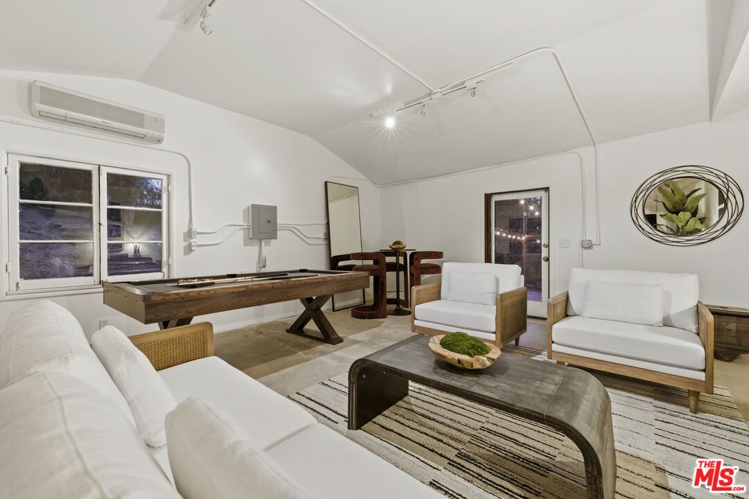 3100 Santa Maria Road Topanga, CA 90290 - Photo 37 of 66 a living room with furniture a rug and wall painting