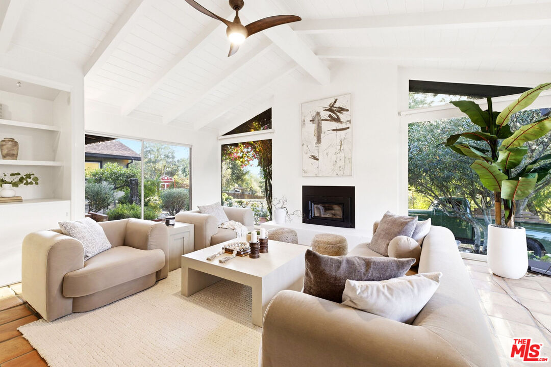 3100 Santa Maria Road Topanga, CA 90290 - Photo 4 of 66 a living room with furniture fireplace and a large window