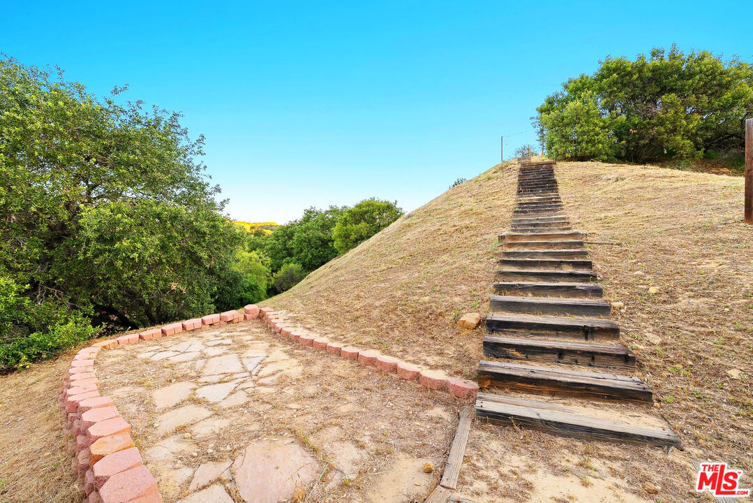 3100 Santa Maria Road Topanga, CA 90290 - Photo 47 of 66 a view of a large white building with wooden fence
