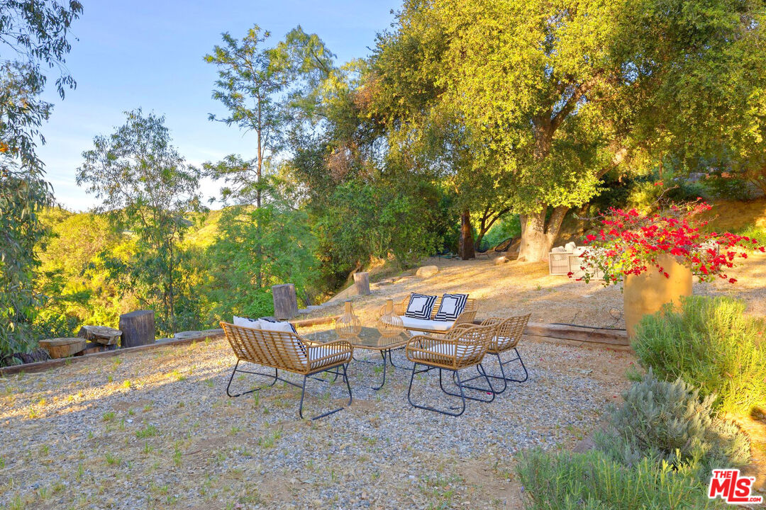 3100 Santa Maria Road Topanga, CA 90290 - Photo 55 of 66 a backyard of a house with table and chairs
