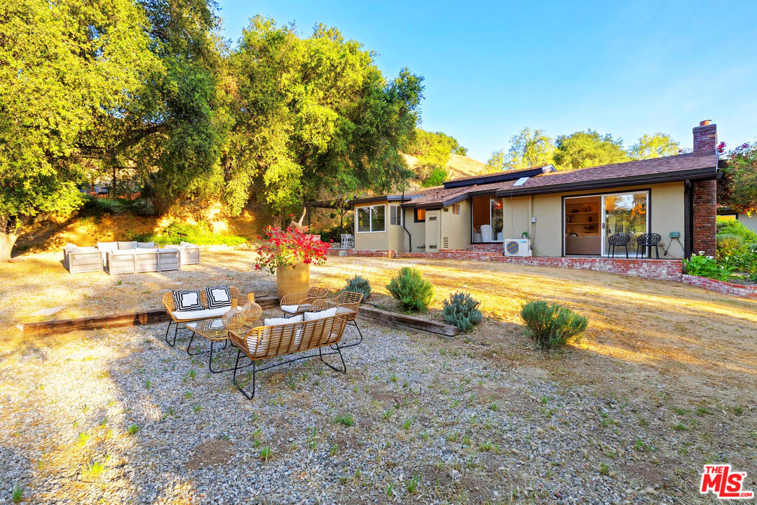 3100 Santa Maria Road Topanga, CA 90290 - Photo 56 of 66 a view of a house with swimming pool and sitting area