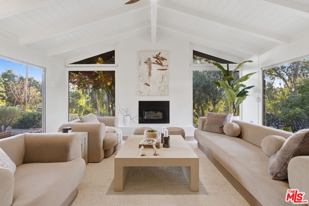 3100 Santa Maria Road Topanga, CA 90290 - Photo 6 of 66 a living room with furniture fireplace and a large window