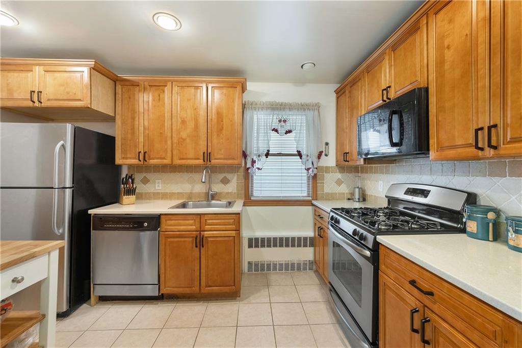 5905 Ave. M Brooklyn, NY 11234 - Photo 11 of 12 a kitchen with stainless steel appliances granite countertop a stove a sink dishwasher and a refrigerator