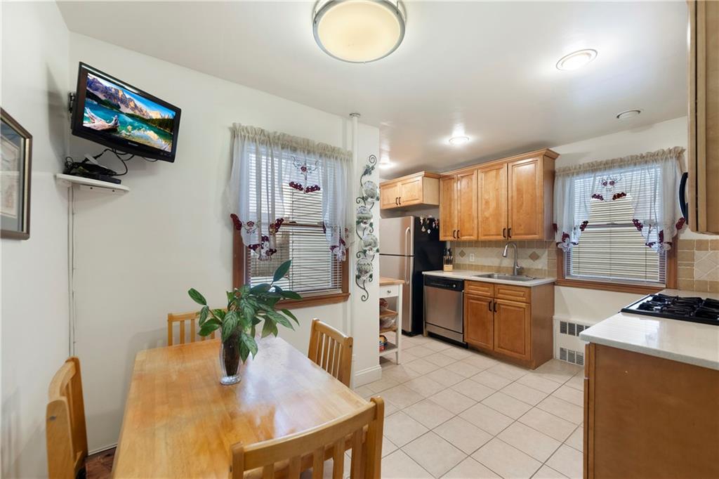 5905 Ave. M Brooklyn, NY 11234 - Photo 10 of 12 a kitchen with stainless steel appliances granite countertop a sink a stove and a refrigerator