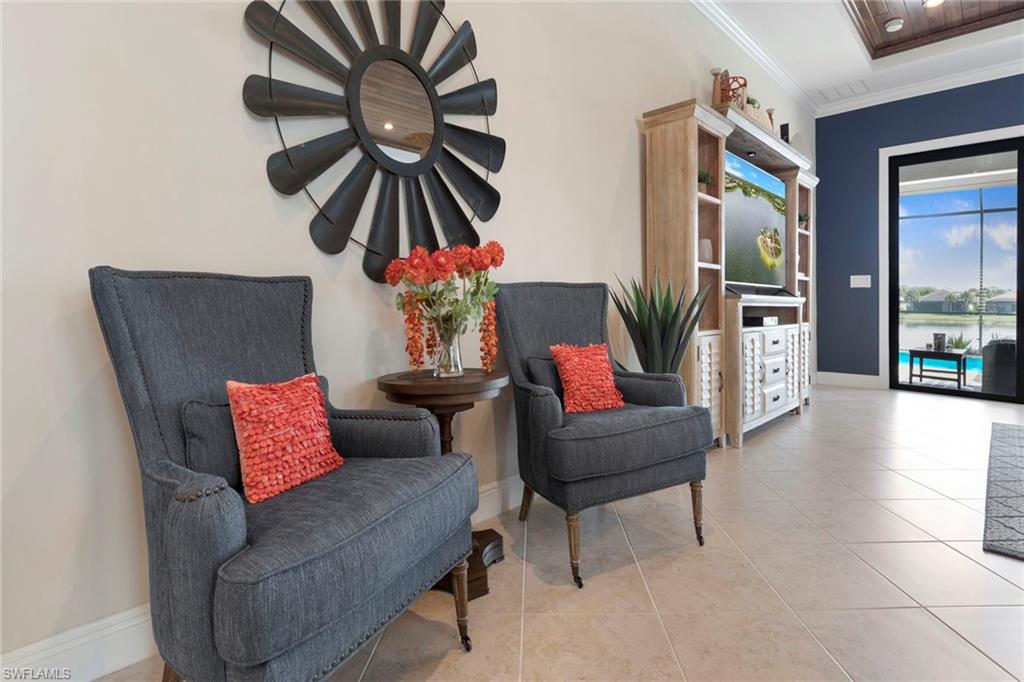 1410 Redona Way Naples, FL 34113 - Photo 11 of 50 a living room with furniture and a large window
