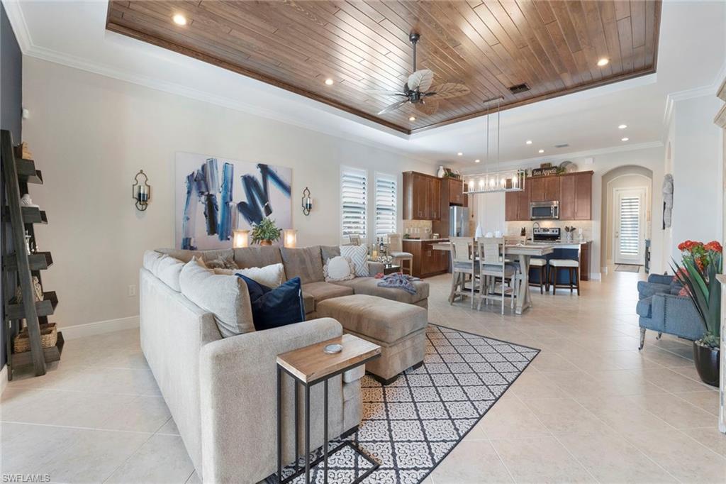 1410 Redona Way Naples, FL 34113 - Photo 19 of 50 a living room with furniture and kitchen view