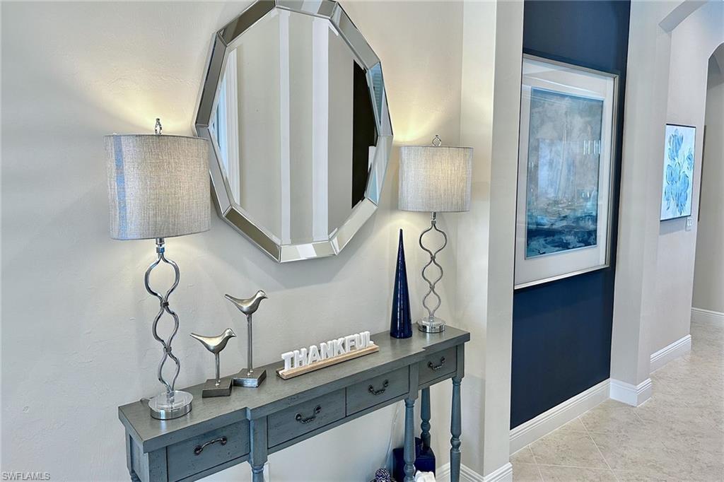 1410 Redona Way Naples, FL 34113 - Photo 27 of 50 a bathroom with a sink and a mirror
