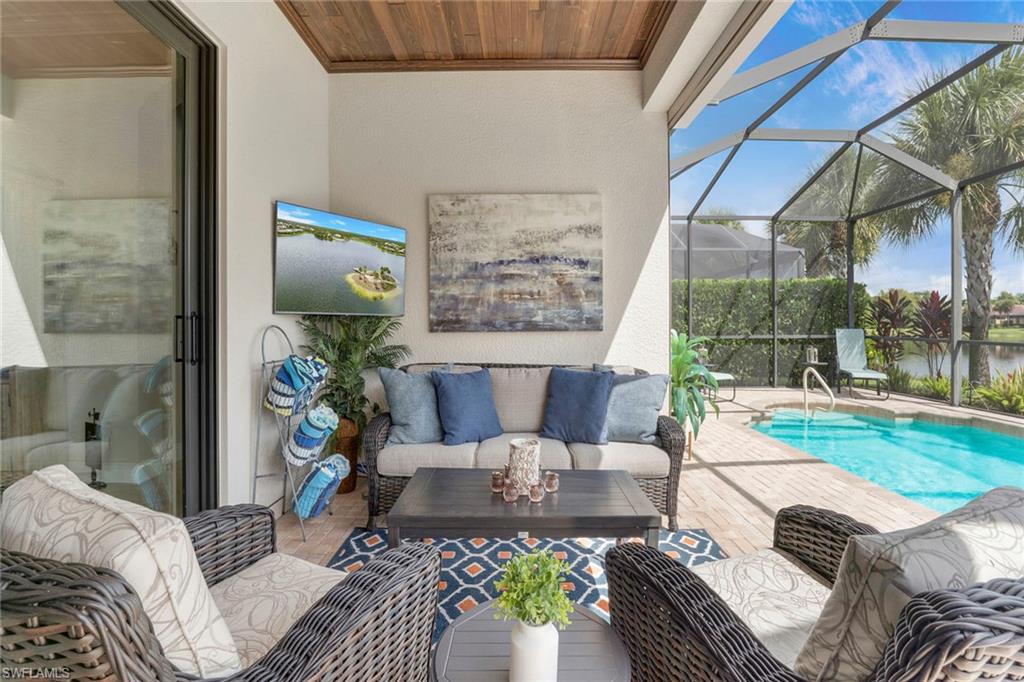 1410 Redona Way Naples, FL 34113 - Photo 3 of 50 a living room with furniture and a garden