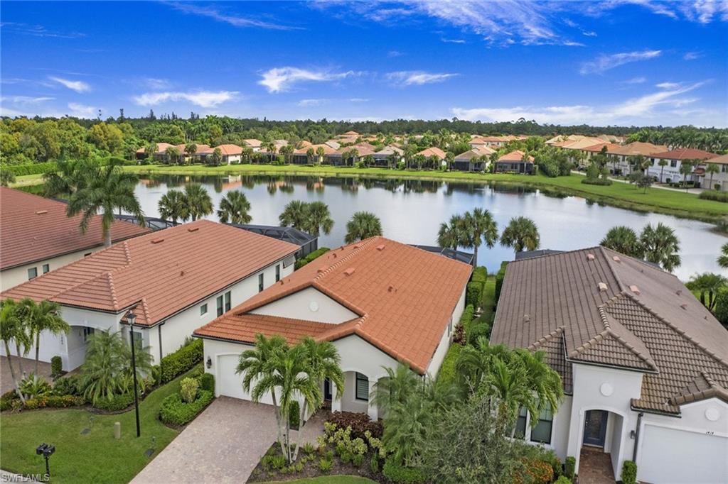 1410 Redona Way Naples, FL 34113 - Photo 34 of 50 a view of a lake with a city